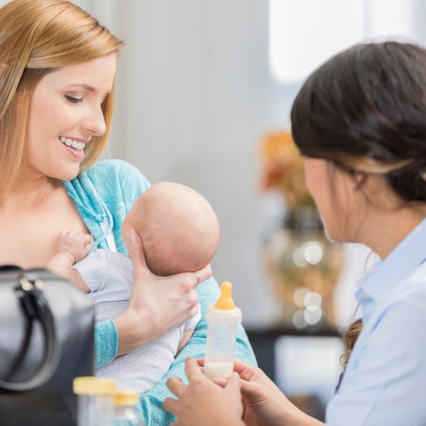 professional breastfeeding consultant helping a mom holding a baby